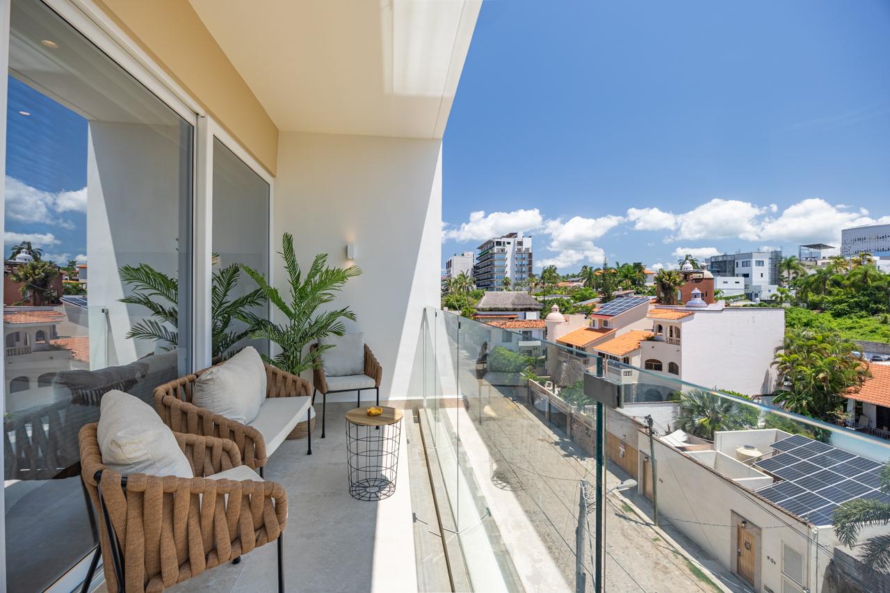 Balcony view of terracotta rooftops and the Sierra Madre
