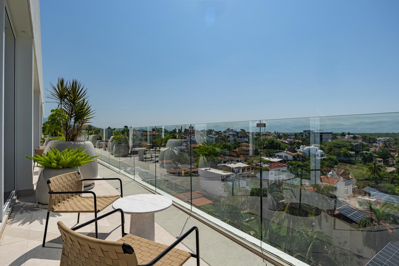 Terrace lounge chairs overlooking Bucerías rooftops and the Sierra Madre
