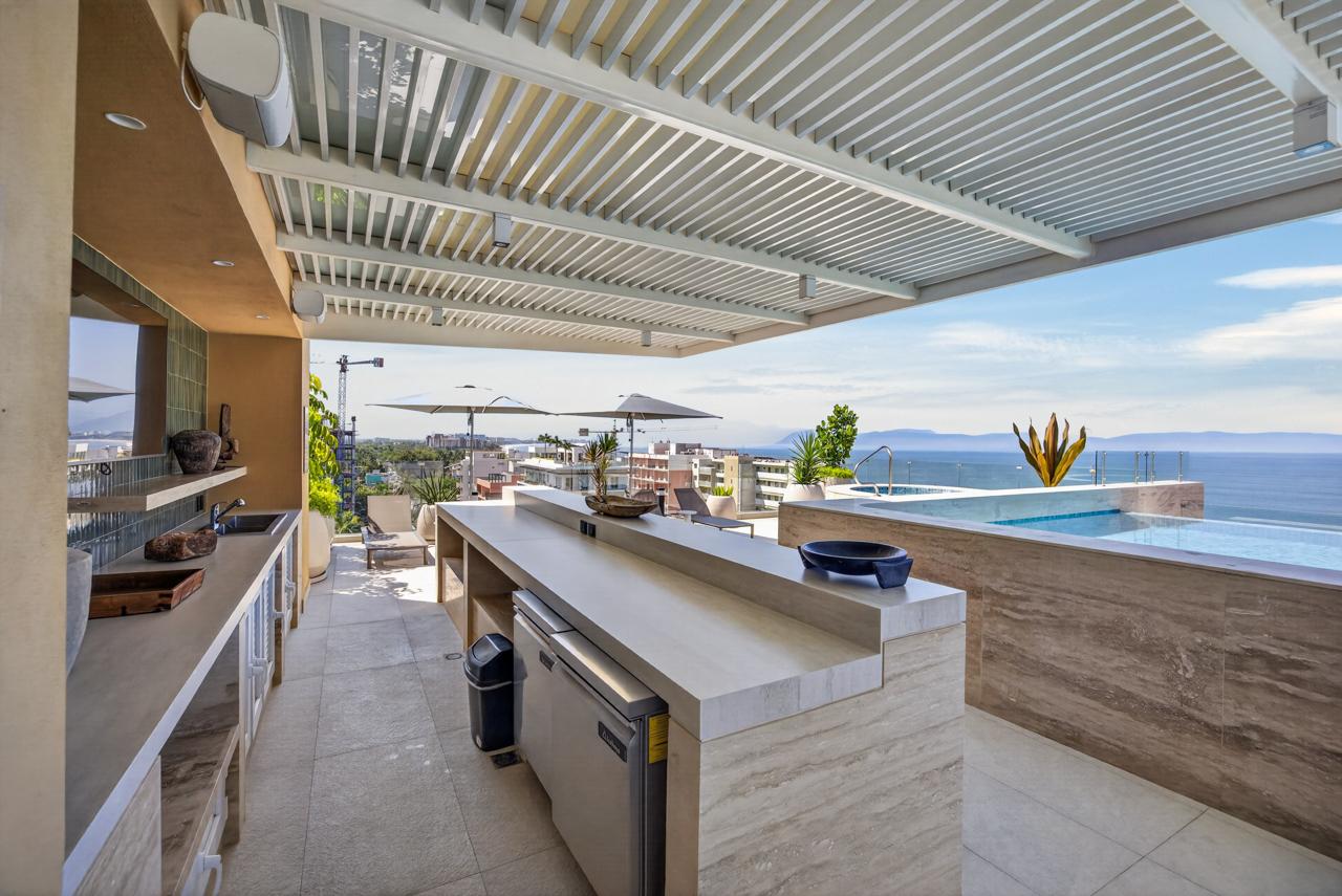 Rooftop bar counter overlooking the infinity pool and the Pacific