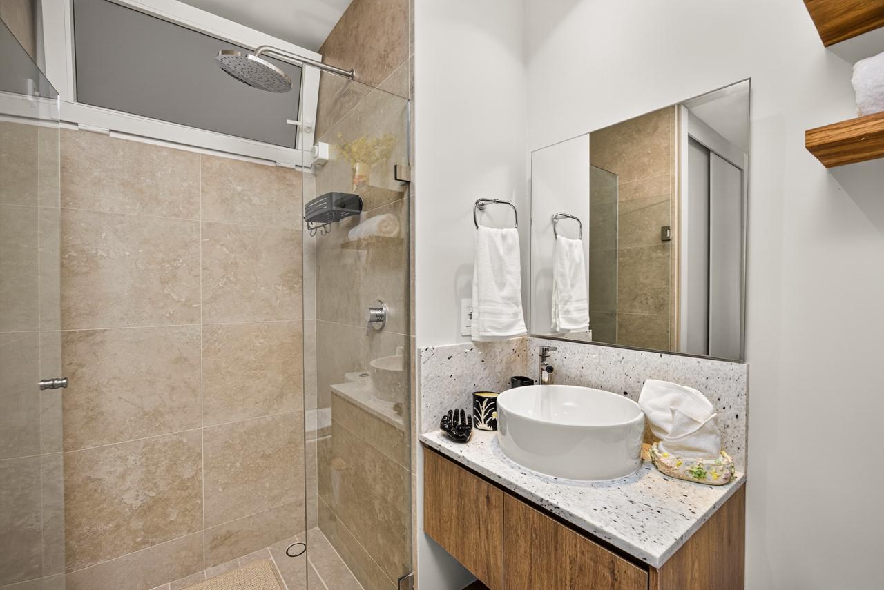 Bathroom with walk-in rain shower and stone vanity