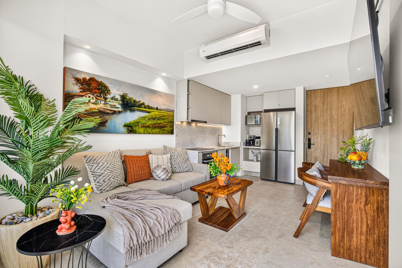 Living room and kitchen at Casa Nayah with sofa, dining bar and stainless appliances